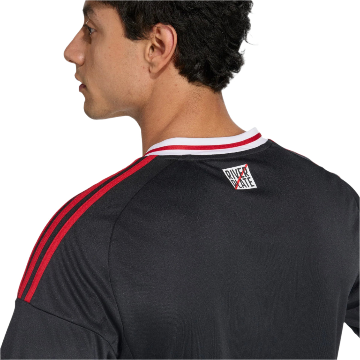 Person wearing a black sports jersey with red stripes on a white background