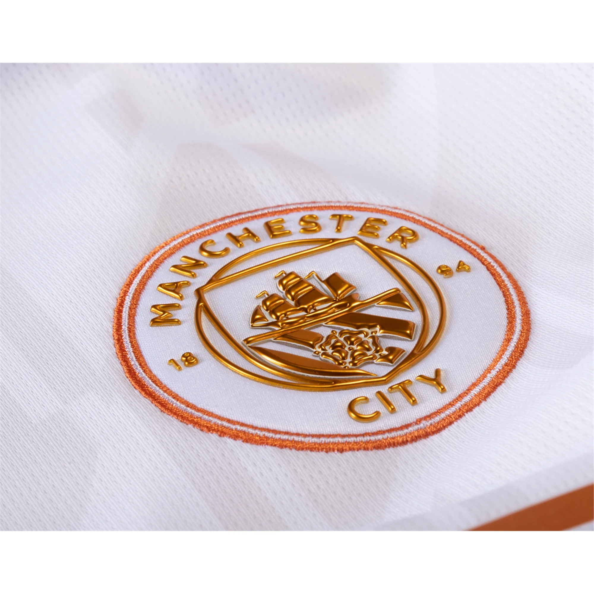 What's the Gold Badge on Manchester City's Jersey?
